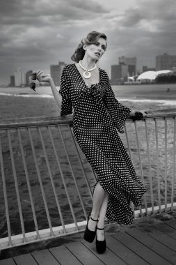 Romantik siyah beyaz elbise ve güneş gözlüğü giyen genç kadın portresi