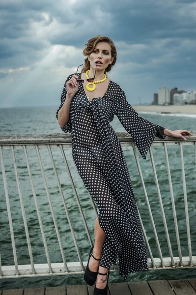 Romantic portrait of young woman wearing black and white dress and sunglasses — Stock Photo, Image