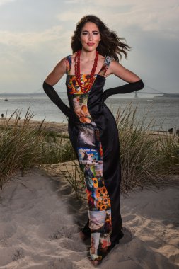 Beautiful charming fashion model in black elegant evening dress