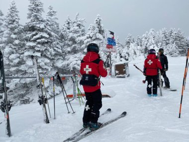 Ski Patrol staff getting ready to work at the top of Stowe mountain clipart