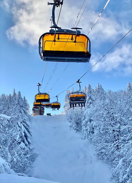 Ski chair lifts at Okemo mountain ski resort at sunny winter day in Vermont USA