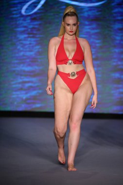 MIAMI BEACH, FLORIDA - 10 Temmuz 2021 'de Miami Beach, Florida' daki Paraiso Çadırı 'nda Bal Birdette için Miami Yüzme Haftası' nda bir model podyumda yürüyor..