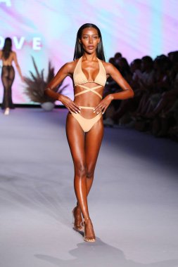 Miami Yüzme Haftası Paraiso Miami Sahili 'nde 9 Temmuz 2021' de Miami Beach, Florida 'da bir manken yeni yüzme markası Neena yüzüşü eşliğinde podyumda yürüyor..