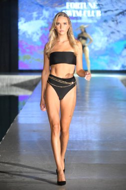 MIAMI BEACH, FLORIDA - JULY 08: A model walks the runway for Fortune Swim Club Show during Miami Swim Week The Shows powered by DCSW on July 08, 2021 in Miami Beach, Florida