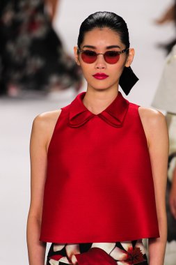 Model Ming Xi walk the runway at the Carolina Herrera fashion show