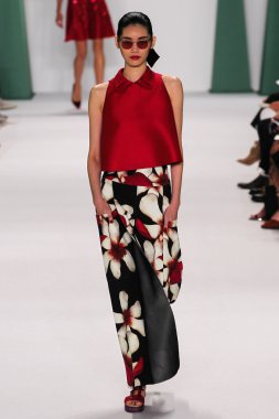 Model Ming Xi walk the runway at the Carolina Herrera fashion show