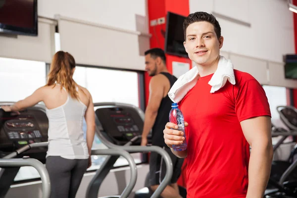 Man with a towel and a bottle of water — Stock Photo, Image