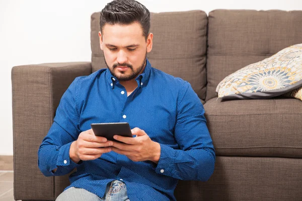 Hombre con barba usando un lector electrónico — Foto de Stock