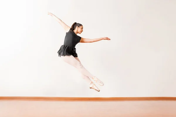Ballerina in a leotard and a skirt jumping — Stock Photo, Image