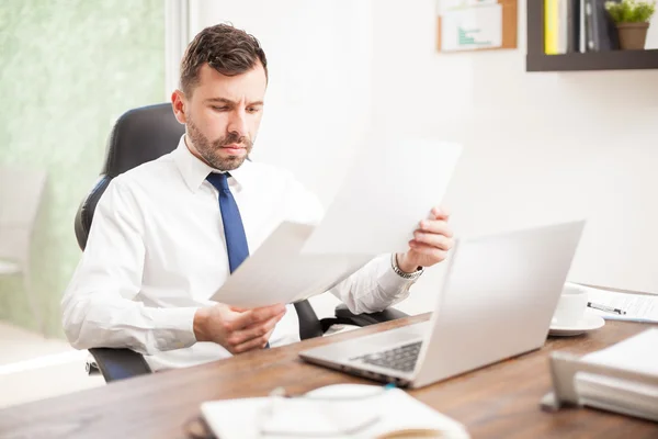 Businessman reviewing some charts — Stock Photo, Image