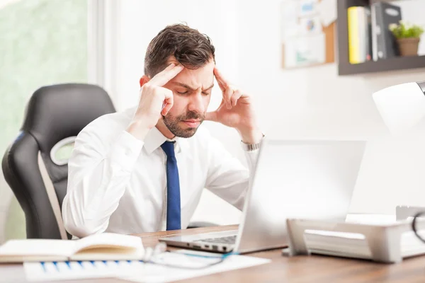 Businessman  touching his temples — Stock Photo, Image