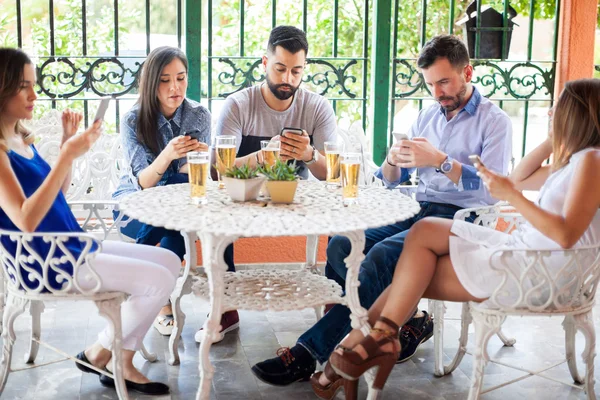 Friends checking over their smartphones — Stock Photo, Image