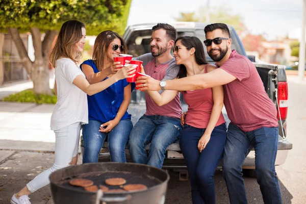 Group of people making a toast with plastic cups — Stock Photo, Image