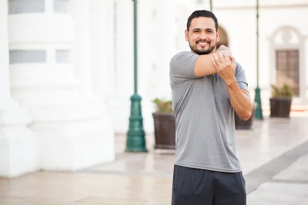 Unner stretching his arms — Stock Photo, Image