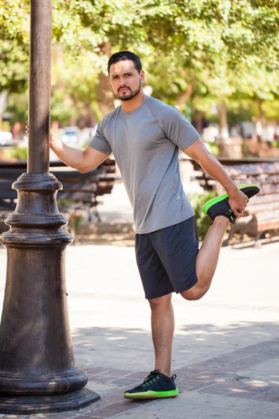 Young Hispanic man stretching — Stock Photo, Image