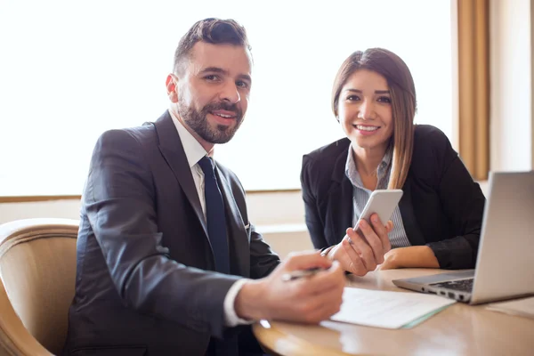 Businessman and  partner looking at a smartphone — Stock Photo, Image