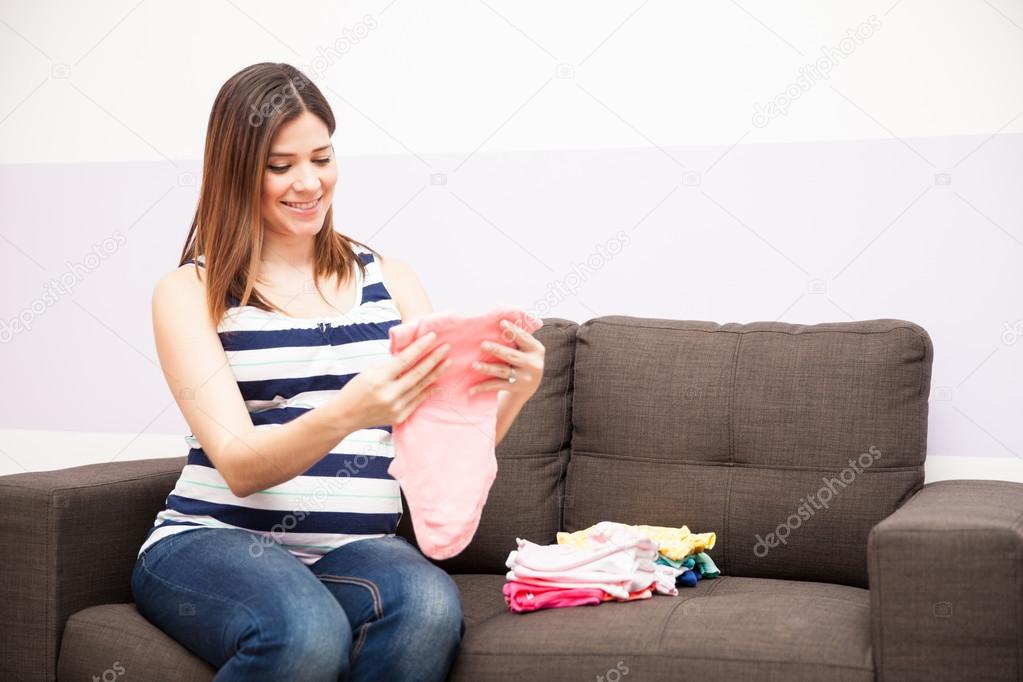 woman Looking at baby clothes 