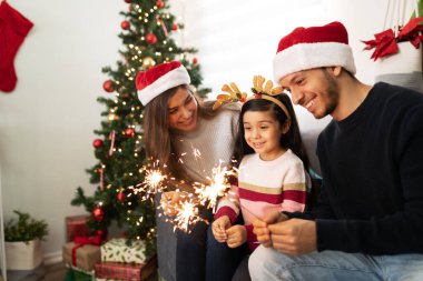 Evde havai fişek kullanan İspanyol bir ailenin portresi. Küçük bir kız Noel 'de çok etkilenmiş görünüyor.