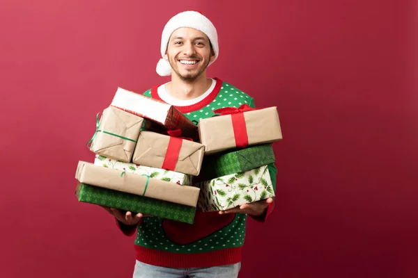 Happy Hispanic Man Santa Hat Carrying Many Christmas Presents Studio — Stock Photo, Image