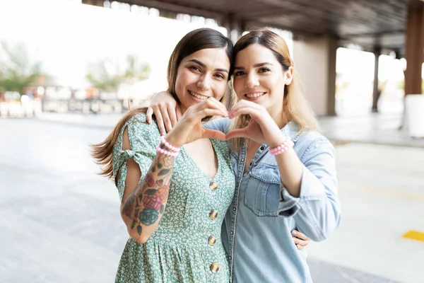 Portrait Two Young Women Friends Making Heart Sign Joining Hands — Stock Photo, Image