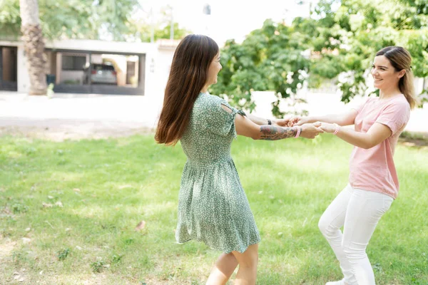 Two Beautiful Friends Holding Hands Twirling Green Grass Park — Stock Photo, Image