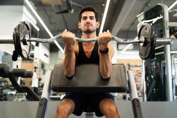 Handsome Hispanic Young Man Sitting Gym Machine Lifting Weights Barbell — Stock Photo, Image