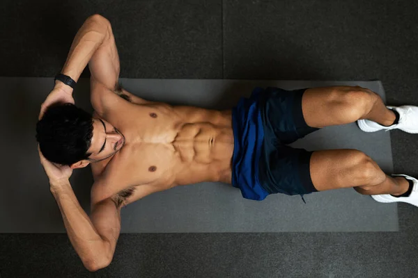 High Angle Shirtless Young Hisspanic Man Doing Abdominal Crunch Exercises — Stock Photo, Image