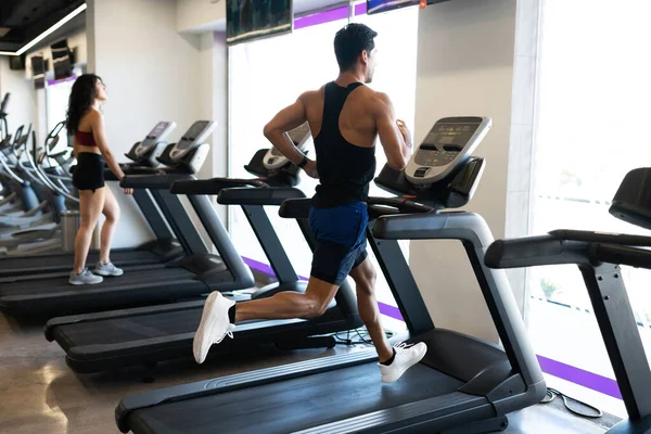 Handsome Hispanic Man Looking Out Window Exercising Running Machine — Stock Photo, Image