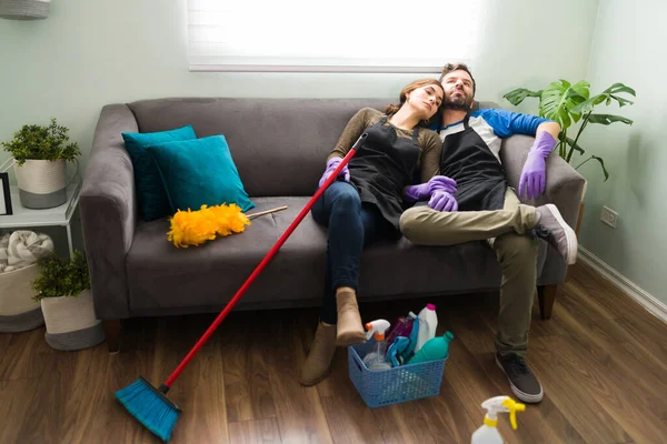 Unhappy Latin Couple Sick Tired Cleaning Doing Chores Sitting Couch — Stock Photo, Image