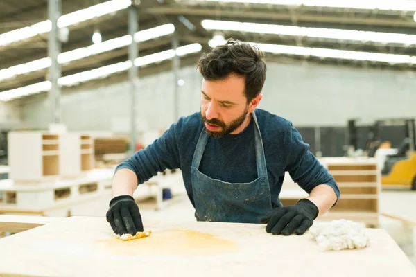 Handsome Carpenter Focused Staining Wooden Table Just Finished Hispanic Man — Stock Photo, Image