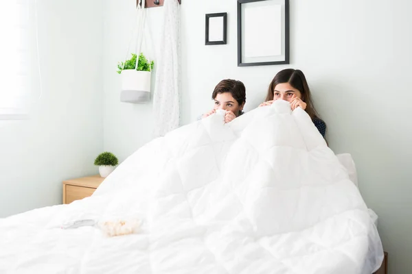 Scared Female Best Friends Watching Horror Movie Bed Hiding Covers — Stock Photo, Image