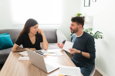 Kızgın İspanyol adam karısına borçları ve giderleri hakkında şikayette bulunuyor. Parasal sorunlar yüzünden evde kavga eden üzgün bir çift.