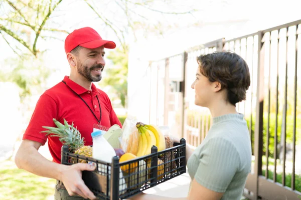 Happy Courier Red Uniform Delivering Box Products Supermarket Doorstep Young — Stock Photo, Image