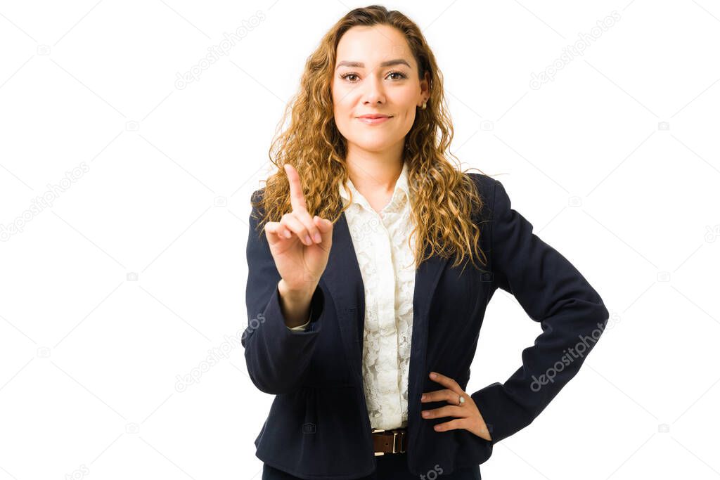 Successful businesswoman just got a promotion and saying she is the number one. Attractive woman in her 20s working as a boss and manager 
