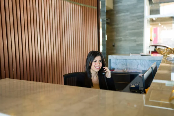 Busy woman and executive receptionist talking on the phone with a client to confirm a meeting appointment at the business center