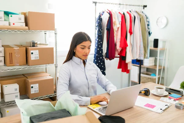 Emprendedora Enfocada Sentada Escritorio Oficina Actualizando Los Productos Nueva Ropa — Foto de Stock