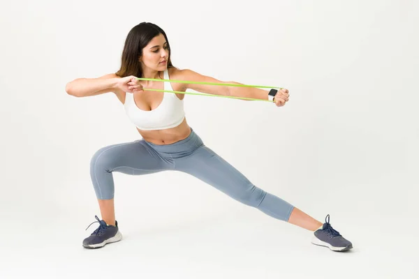 Athletic Woman Doing Lunges Working Out Her Arms Strength Band — Stock Photo, Image