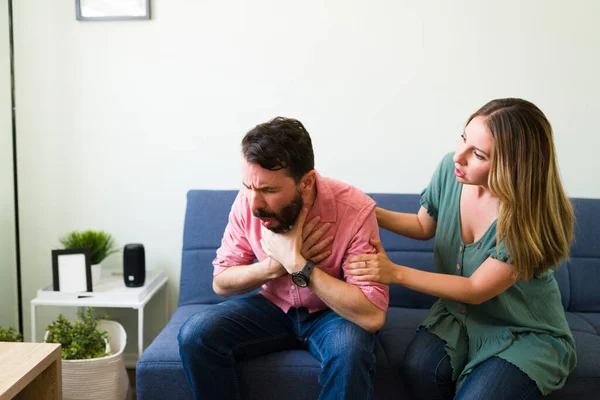 Adult Latin Man Choking Piece Food While Sitting Sofa His — Stock Photo, Image