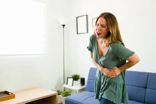 Suffering Woman Standing Living Room While Touching Her Side Stomach — Stock Photo, Image