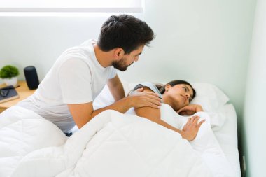 Please, forgive me. Sorry boyfriend asking his angry girlfriend for forgiveness and apologizing after having a big fight before sleeping