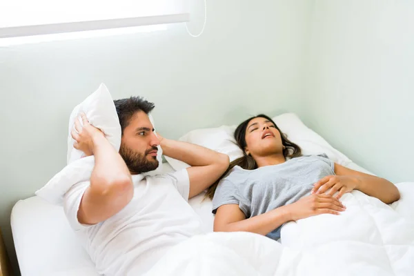 Upset Young Man Covering His Ears Pillow Feeling Angry His — Stock Photo, Image