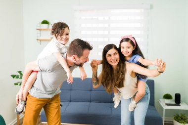 Uçak gibi uçmak için oynuyorsun! Sevgi dolu ebeveynler küçük çocuklarını sırtında taşıyorlar ve evde birlikte vakit geçiriyorlar.