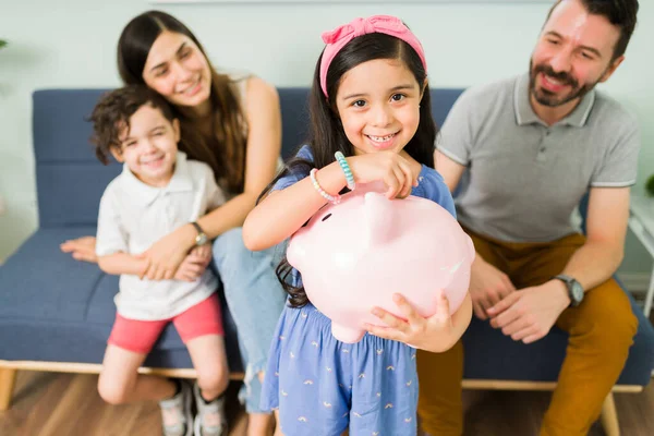 Portrait Cute Little Girl Putting Money Pink Piggy Bank New — Zdjęcie stockowe