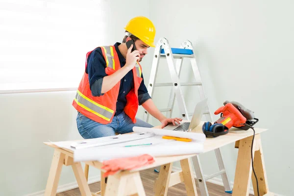 Look Hardworking Contractor Sitting Talking Phone Construction Supplier While Working — Zdjęcie stockowe
