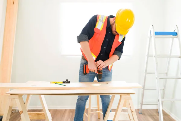 Attractive Carpenter Protective Helmet Glasses Working While Drilling Wooden Bar — Stockfoto