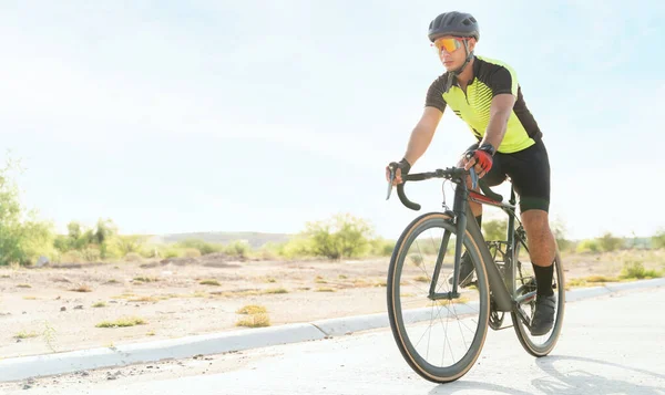 Enjoying my exercise. Professional athlete riding a road bike. Hispanic cyclist pedaling and working out in the morning alone