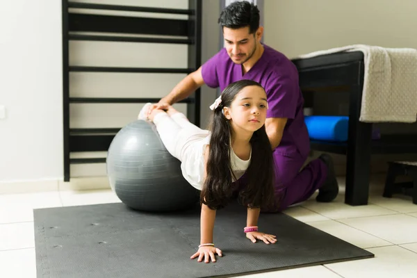 Hispanic Little Girl Exercising Her Muscles Fitness Ball Leg Injury — Stock Photo, Image