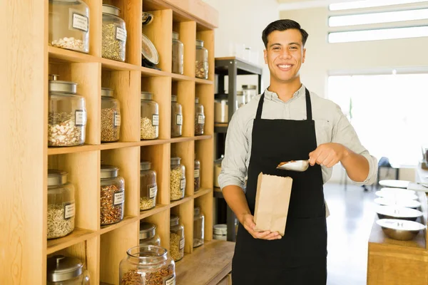 Cheerful Proprietário Negócio Sorrindo Colocar Uma Colher Nozes Saco Papel — Fotografia de Stock