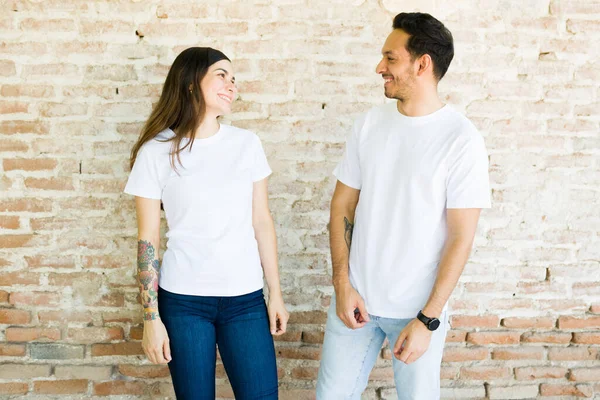 Attractive Young Couple Laughing Having Fun While Wearing White Mock — Stock Photo, Image