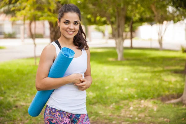 Brunette woman carrying mat — Stock Photo, Image